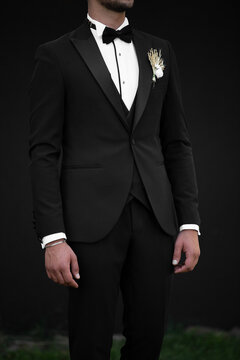 Handsome confident businessman wearing suit isolated on black background black backraund