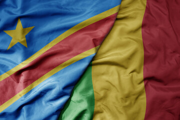 big waving national colorful flag of democratic republic of the congo and national flag of mali .