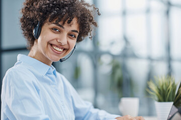 girl in a modern office working in a call center smiling