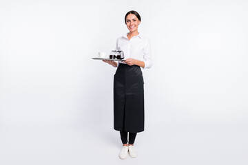 Full length body size photo of cheerful waitress serving client with coffee pot isolated on white...