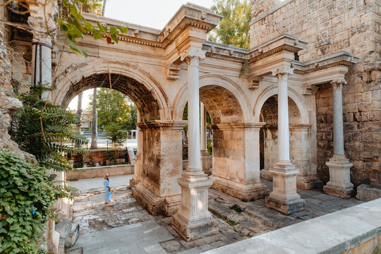 Tourist woman at Hadrian's Gate in Antalya Turkey during summer day.