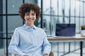 Happy female designer standing in office