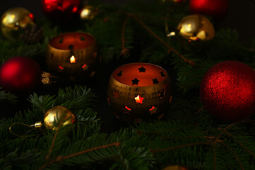 New Year's decor with candlesticks, fir branches and Christmas balls close-up