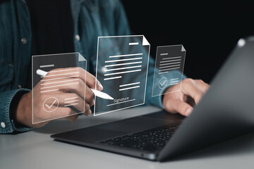 Businessman use laptop and signing electronic documents in digital documents for electronic signature concept. , Signing contract to approve a business project, paperless document office.