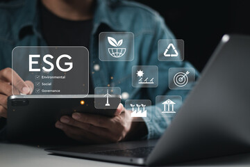 ESG concept, businessman use tablet analyze ESG environment social governance investment business for sustainable and ethical business on network connection.