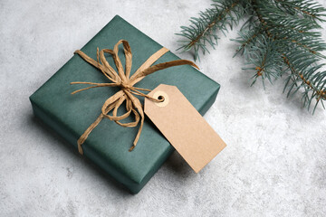 Christmas gift box decorated with craft gift tag or label, mockup with copy space, winter holidays concept