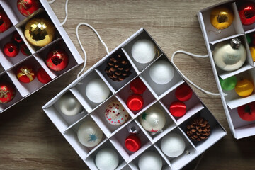 Boxes with various organized Christmas ornaments. Decorating or taking down the Christmas tree. Top view.