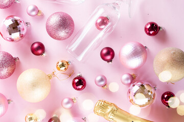 Christmas party with champagne bottle neck and glass on pink background