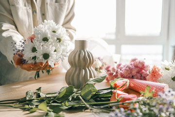 Florist at work. Woman making autumn floral decorations