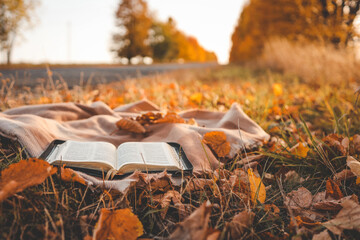 Open Bible on a blanket, autumn