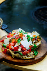 Chicken bruscetta  with vegetables cooking on an outdoor grill