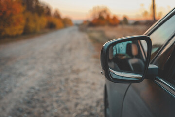 Autumn view from the side mirror of a car