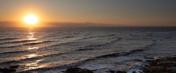 Seascape. Sunrise and waves. Golden light.
