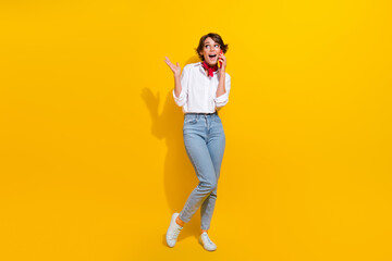 Fototapeta na wymiar Full length photo of positive girl wearing stylish clothes looking up empty space offer proposition isolated on yellow color background