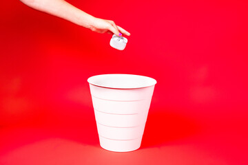 Wireless headphones is thrown into the trash for disposal and recycling