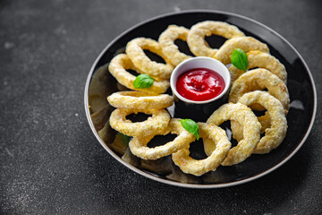 onion rings deep fryer tomato sauce fast food eating cooking meal food snack on the table copy space food background rustic top view