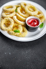 onion rings deep fryer tomato sauce fast food eating cooking meal food snack on the table copy space food background rustic top view