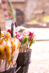 Colorful rainbow color meringue lollipops candy in the basket. Vertical image. 