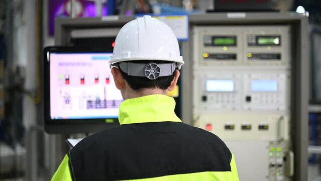 Electrical engineer woman checking voltage at the Power Distribution Cabinet in the control room,preventive maintenance Yearly,Thailand Electrician working at company