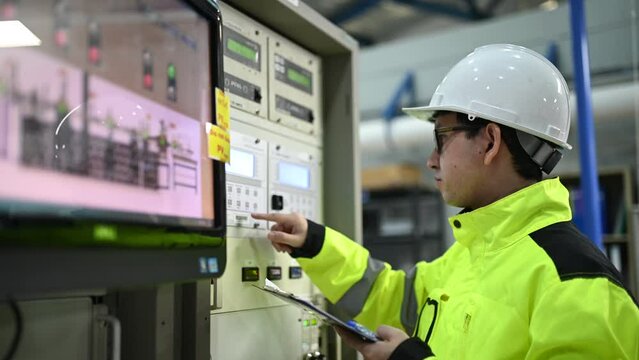 Electrical engineer woman checking voltage at the Power Distribution Cabinet in the control room,preventive maintenance Yearly,Thailand Electrician working at company