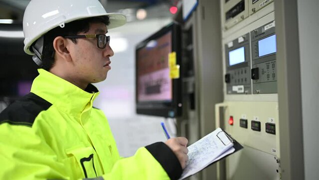 Electrical engineer woman checking voltage at the Power Distribution Cabinet in the control room,preventive maintenance Yearly,Thailand Electrician working at company