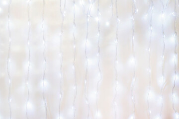 garland illumination for the holidays and Christmas with glowing light bulbs made from lines along the perimeter of the wall or background