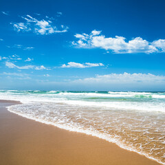 Fototapeta na wymiar Yellow sand beach, sea and deep blue sky..