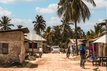 African road through village people going about business - obrazy, fototapety, plakaty