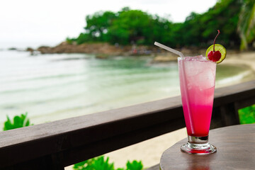 Cocktail on the table and sea in background.
