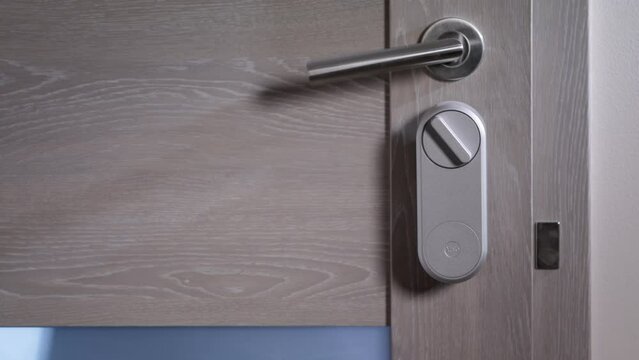 Electric lock on the door. Door and security and control system. Electronic and remotely controlled key. A person passes through a control point. Door handle and smart lock. 