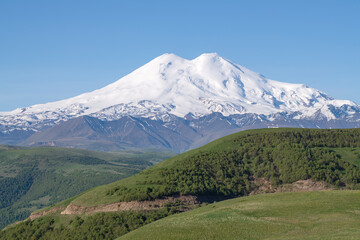 Fototapeta premium Elbrus Mount in the morning June landscape. Kabardino-Balkaria, Russia