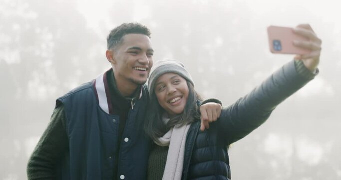 Couple, camping and selfie with smile, woods and peace sign with memory, fog and winter morning on vacation. Young man, woman and happy outdoor for profile picture, photography and romance in forrest