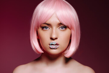 Glamorous portrait of a young woman with pink hair and glitter on her lips. A Chic Expression of...