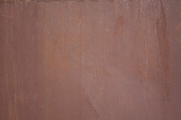 A close-up view of a weathered rusty metal surface. The texture and colors show the effects of time and elements.