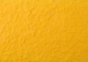 Yellow plasticine texture background. Modeling clay material pattern.