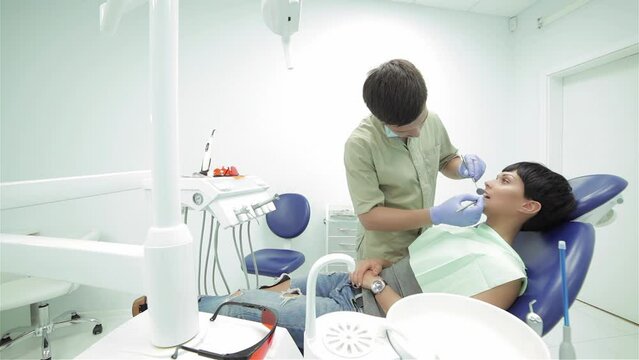 Dentist standing over the patient