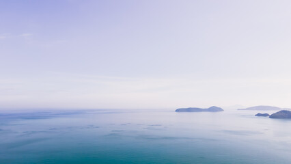 Aerial view of blue water surface background and sun reflection. aerial view of a flying drone Waves surface on a tropical ocean with bright sunlight. Perfect for vacations, in the island of Phuket 