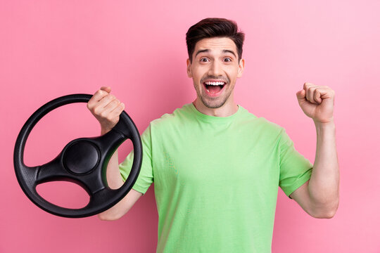 Photo of young funny man raised fist up when shouting celebrating final exam passing got driver license isolated on pink color background