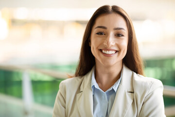 Fototapeta premium Headshot portrait of cheerful pretty confident young woman in suit enjoy work in city outdoors