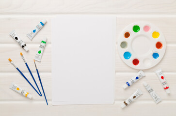 Painting tools on wooden background, top, view