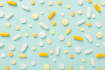 Flat lay with different medical pills and capsules on color background