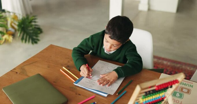 Creative, boy and home with kid education, learning and color activity for development. Top view, school homework and young child with student growth and drawing in house with paper and illustration