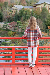 Woman enjoying nature sitting in Japanese Garden