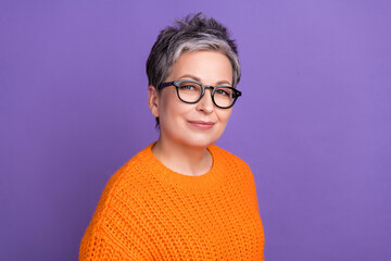 Portrait of confident cheerful person with gray hairstyle wear knit jumper in glasses look at camera isolated on violet color background
