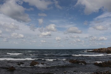 It's a description of the beach in Sokcho, South Korea, with scattered ancient rocks and a very...