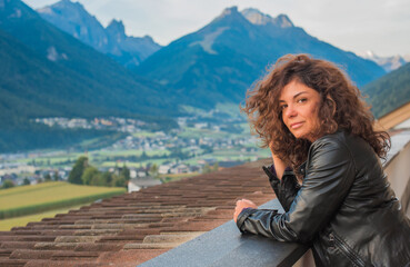 Fototapeta na wymiar Latina woman on vacation in Alps mountains in Austria. Holidays and vacation concept