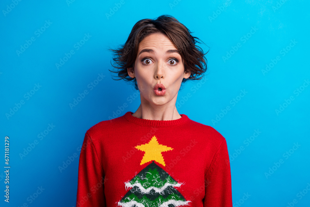 Sticker Photo of positive impressed lady santa helper dressed print sweater big eyes enjoying xmas isolated blue color background