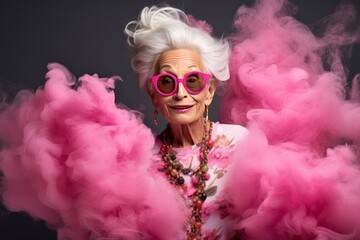 Vibrant Senior Lady Exudes Fashionable Charm with Playful Pink Attire and Retro Glasses.Lady in pink