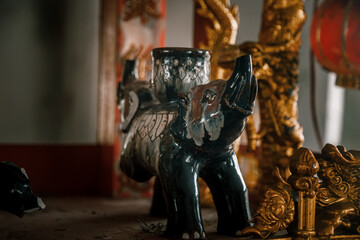 Broken elephant figurine in an abandoned building. Religious Buddhist figurine of an elephant.	
