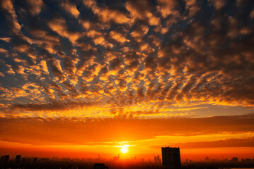 Sunrise over the city with red clouds